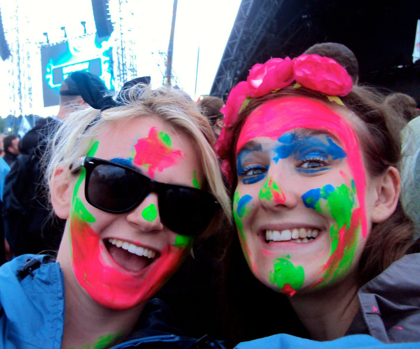 Girls with face paints in the crowd