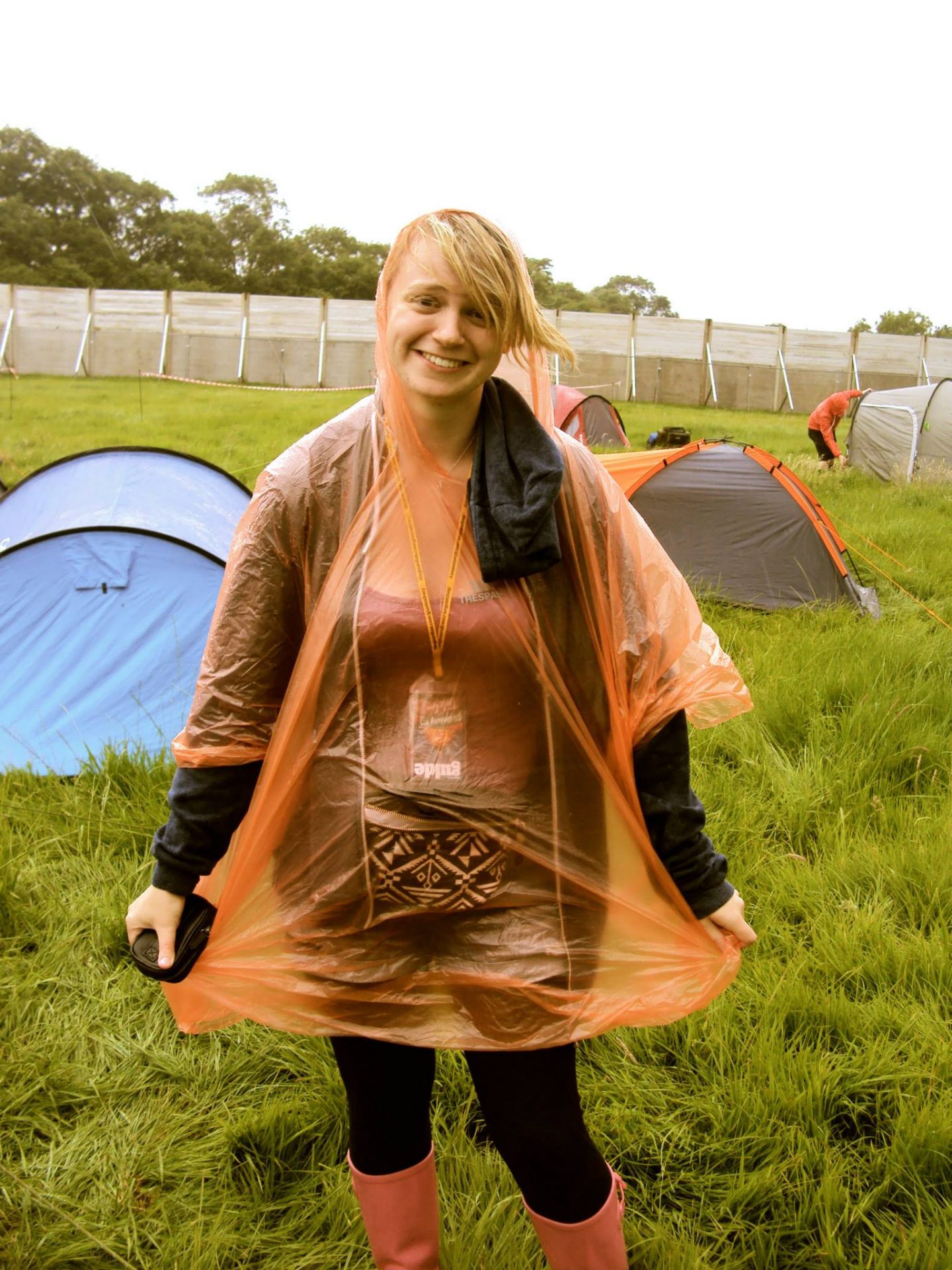 Laura with a poncho on at Glastonbury Festival
