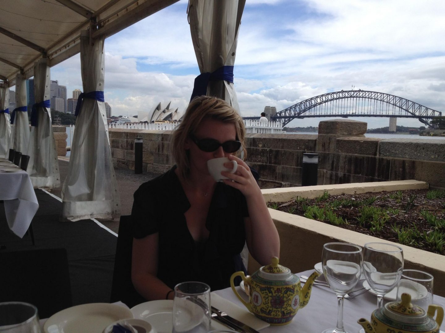 Laura drinking tea with Sydney Harbour Bridge in the background