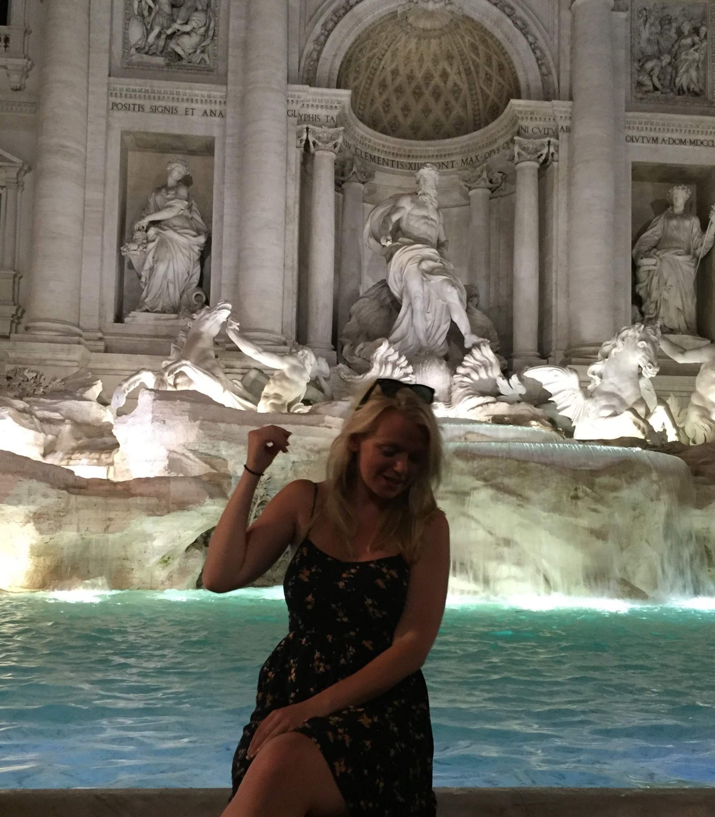 Laura throwing a coin in the Trevi Fountain