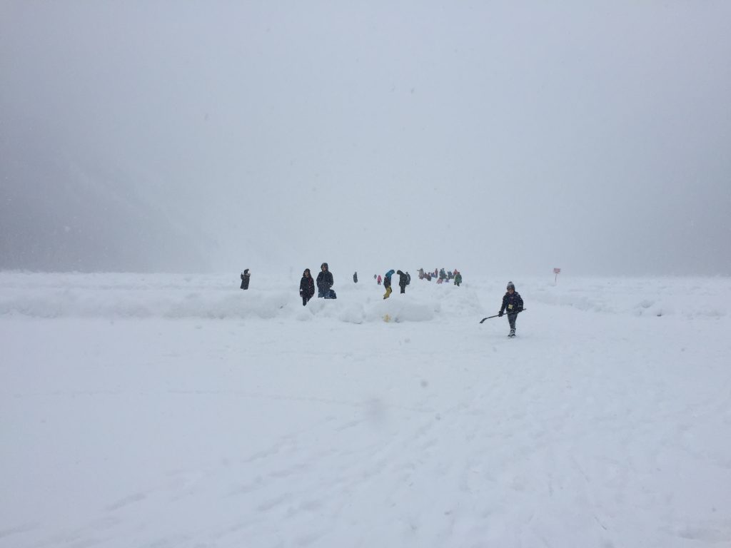 Kids playing ice hockey and skating on Lake Louise