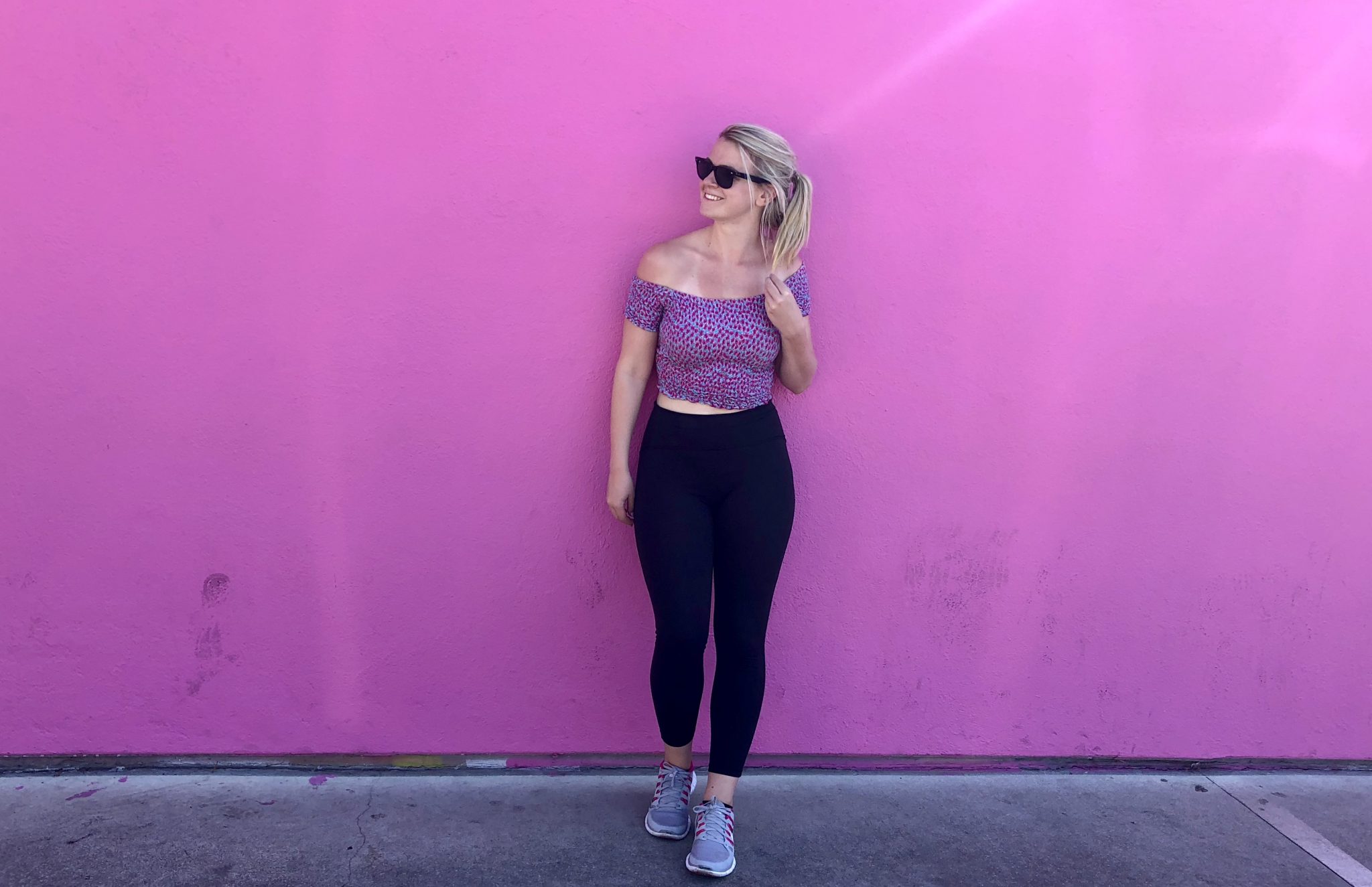 Laura stood in front of the Paul Smith pink wall on Melrose Avenue, Los Angeles